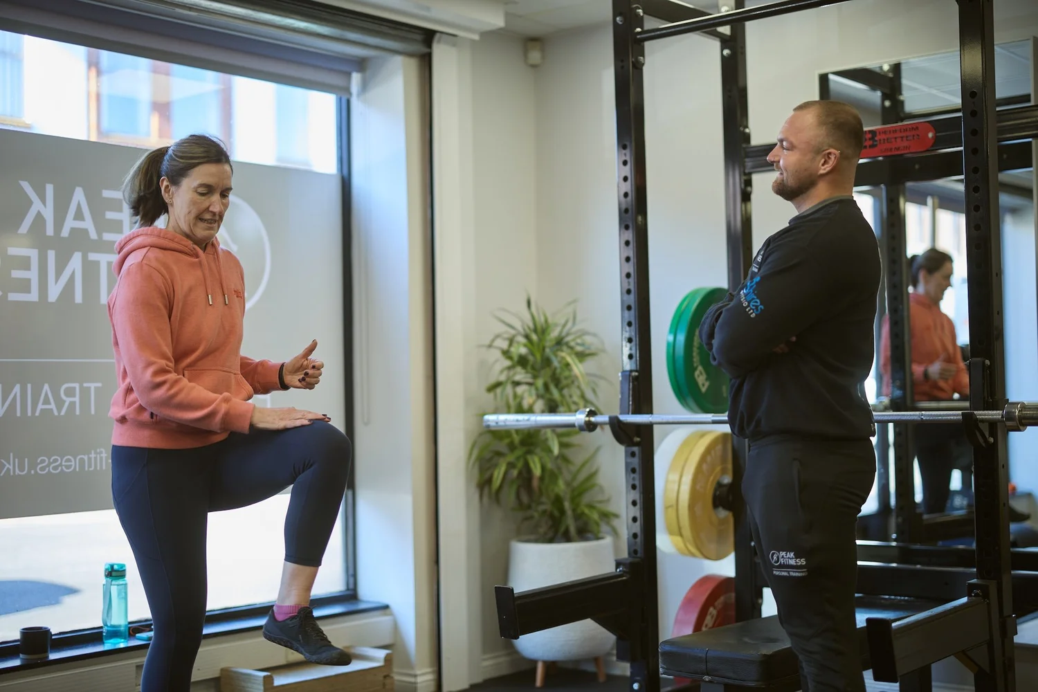 A Peak Fitness coach talking through a session with a client